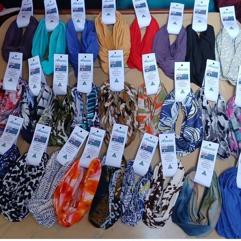 The full range laid out in rows — turquoise, purple, coral, navy, grey and several printed patterns — each with a hangtag